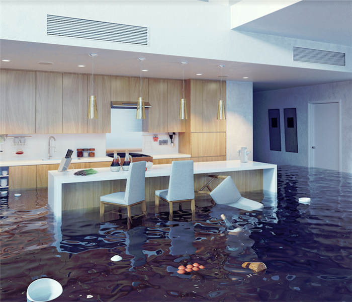 a flooded kitchen with furniture floating everywhere